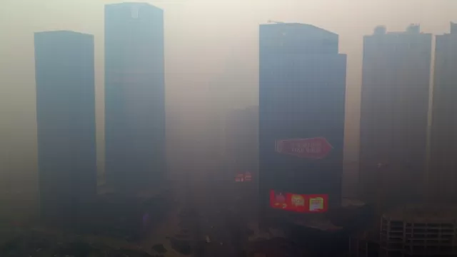 Un edificio residencial cubierto de smog. (Vía: AFP)