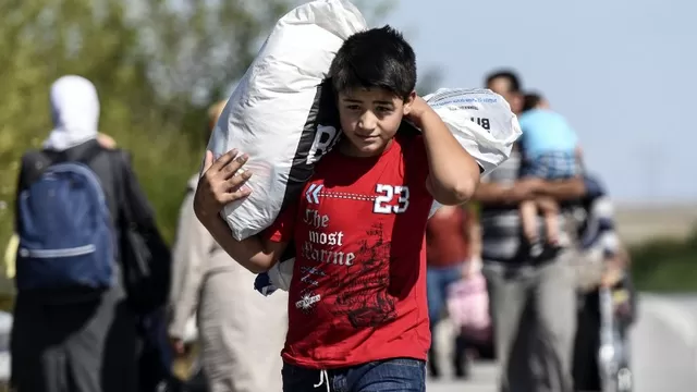 Un joven migrante sirio carga un saco mientras hacen su camino a lo largo de la carretera hacia el turco-b&uacute;lgara. (V&iacute;a: AFP)